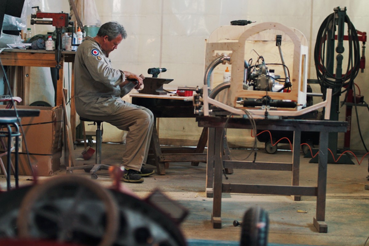 Frank Bankonin macht eine Pause beim Bau seiner Seifenkiste in Form von einem Oldtimer; 